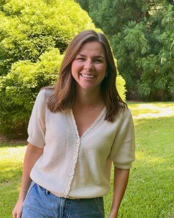 Portrait of Lauren smiling in her garden